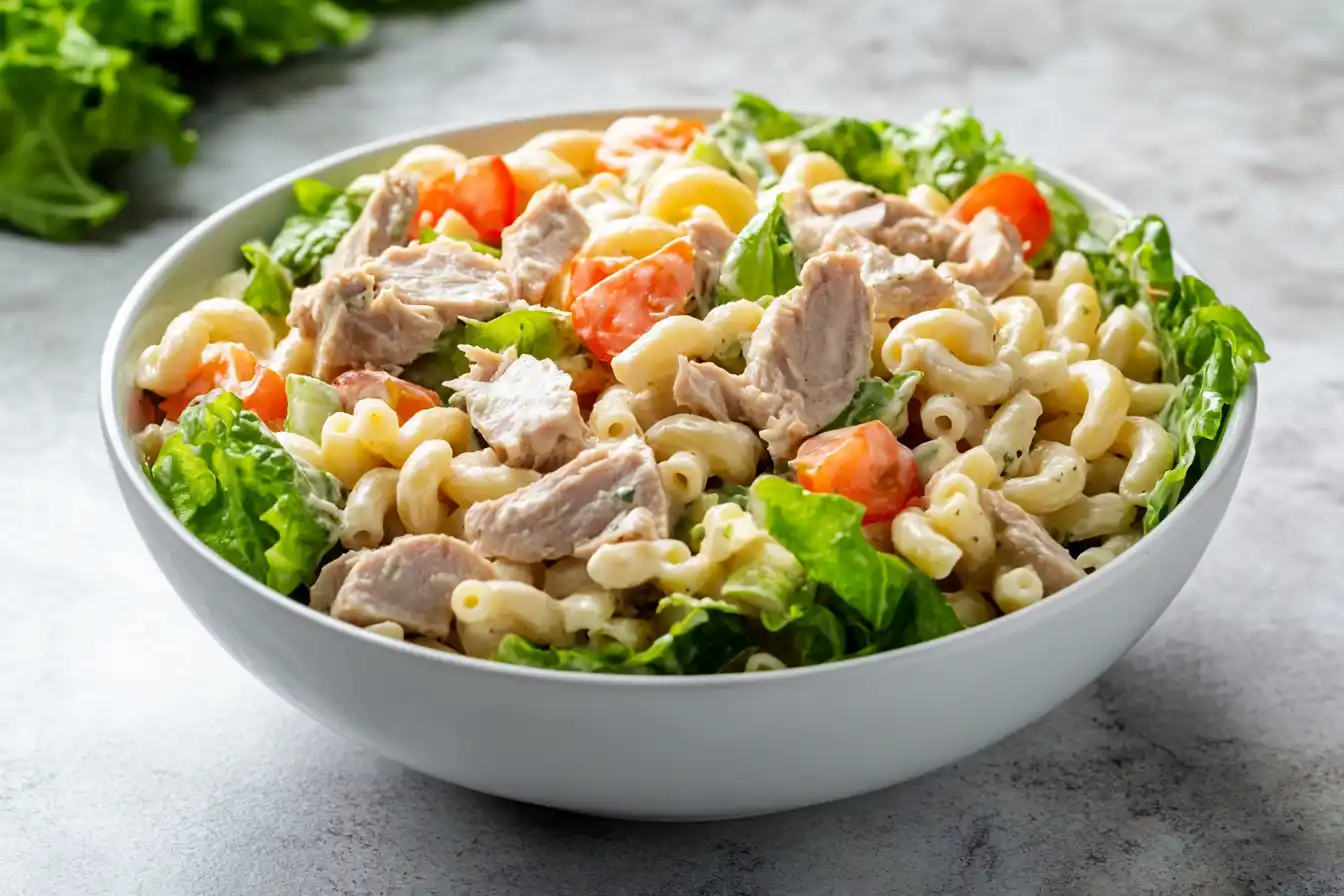 Close Up Of The Finished Macaroni Salad With Tuna, Creamy Dressing Mixed In, And Fresh Ingredients In A Large Serving Bowl, Ready To Chill